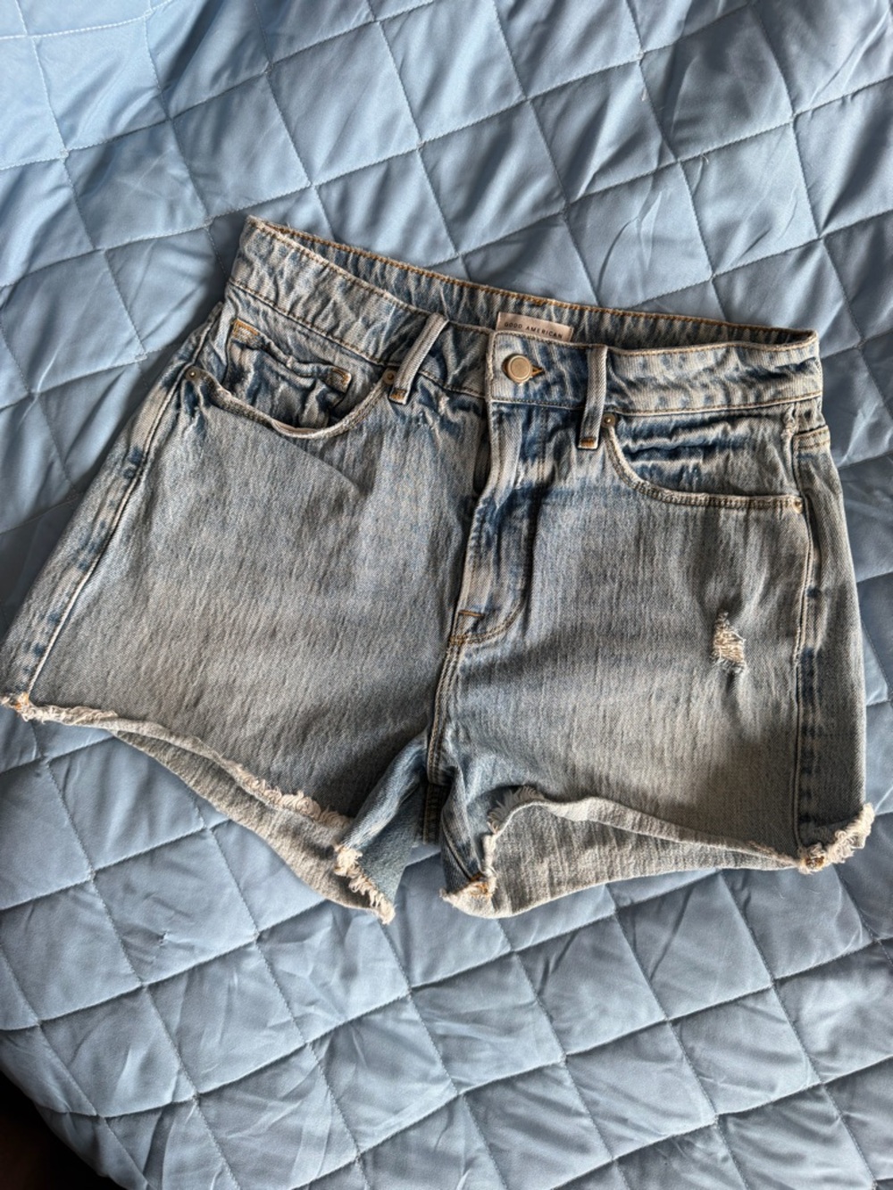 Good American Light Blue Distressed Denim Cutoff Shorts